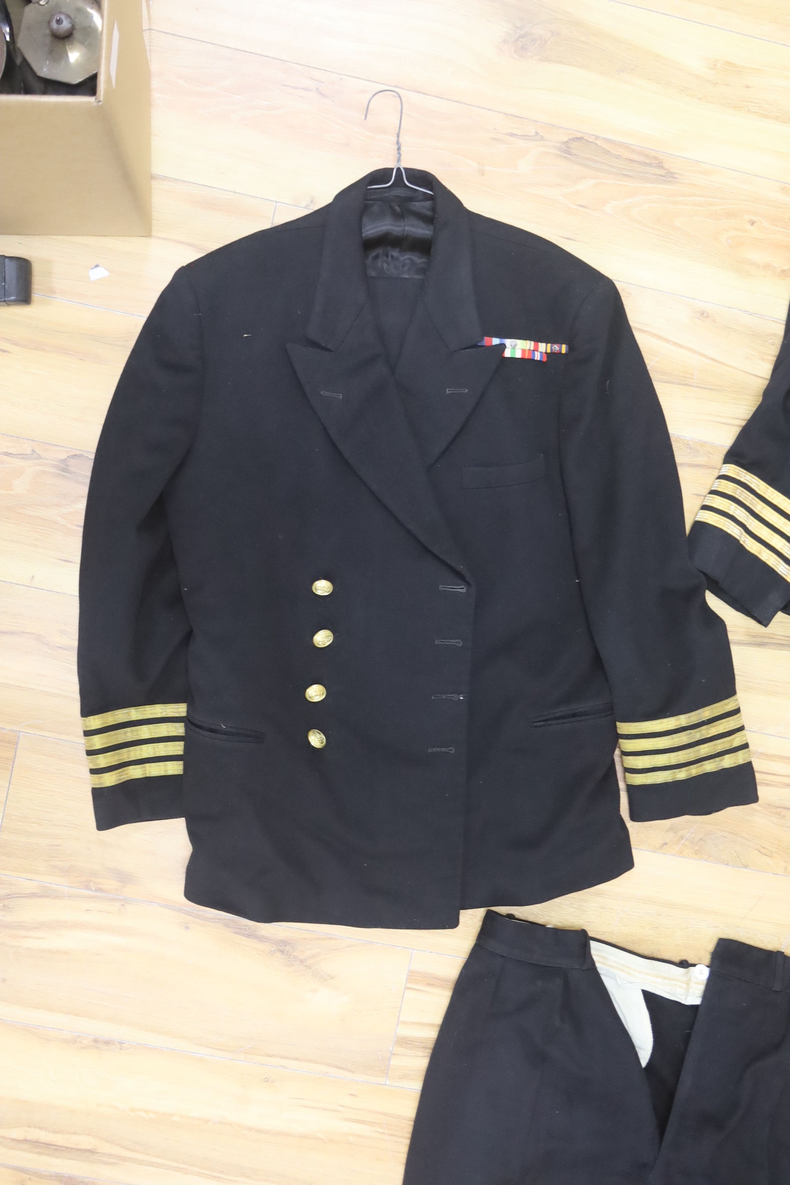 Two Royal Navy Captains jackets and associated trousers